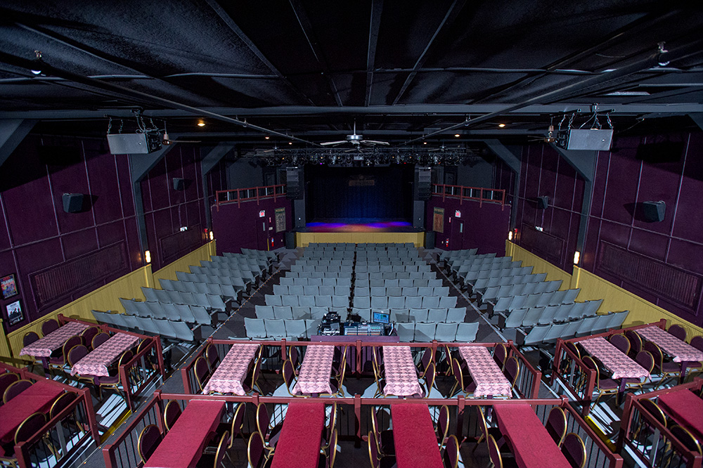 full view from back of house of floor seating and stage ahead